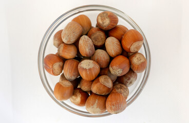 Hazelnuts inside a glass bowl.