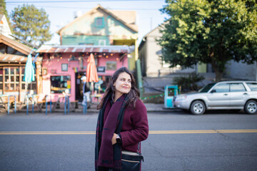 Fototapeta premium Beautiful woman smiling and walking in the street