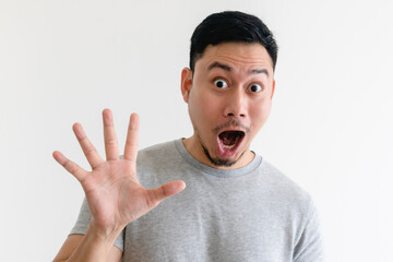 Surprised face Asian man making number hand sign on isolated white background.