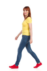 Casual Young Woman Is Walking And Looking At Camera
