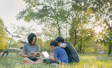 Asian family relax at the public park