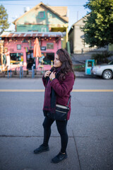 Beautiful woman smiling serenely and standing in the street