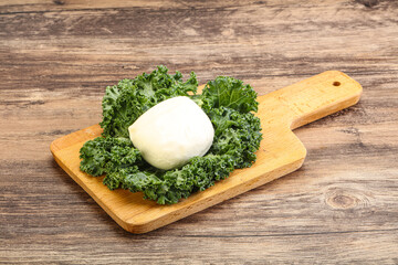 Soft mozzarella cheese over board