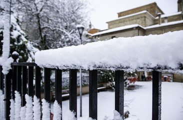 Metal railing full of snow