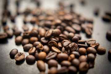 Coffee beans scattered on blurry background