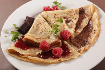crepe with chocolate spread and raspberry fruit jam