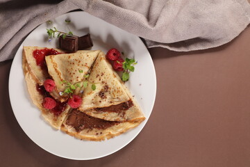 crepe with chocolate spread and raspberry fruit jam