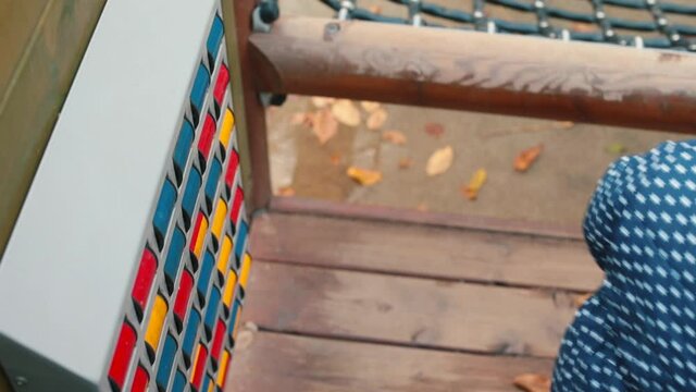 A child on the playground uses a color learning device. Children are constantly learning through play. Community playgrounds provide kids the opportunity to practice and hone key skills.