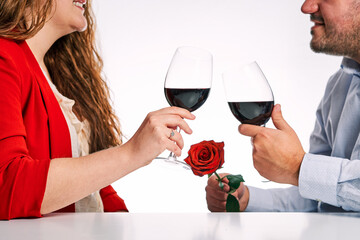Couple toasting with a glass of wine together. Concept of Valentine's Day and couple in love.