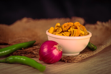 Mix khatta meetha namkeen mixture(frali) with onion and chili peppers,