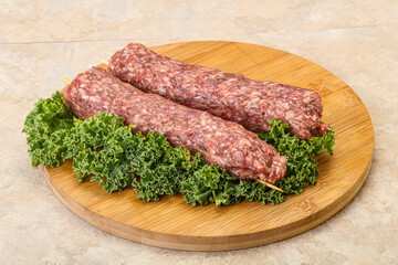 Raw minced beef kebab skewer