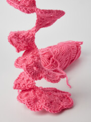 Needlework crochet, top view of yarn balls, flat spoon on light wood close-up