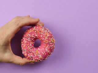 hand holding a donut