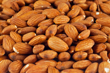 Almonds close up. Texture of nuts. Lots of nuts in a pile.