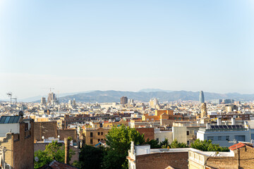 Fototapeta na wymiar Aerial view of the Barcelona skyline with many buildings on a sunny summer day