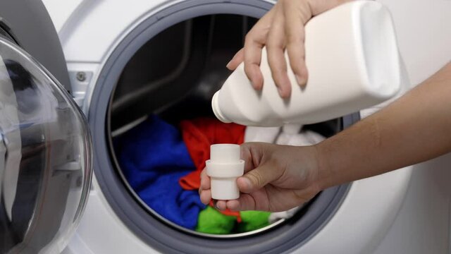 Pour some laundry detergent on the clothes and put it in the washing machine
