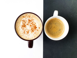 Coffee concept. Drink background. Creative layout made of Cappuccino on white background and coffe on black background.  Top view image of coffee cup. 