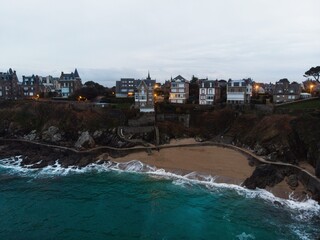 Aerial panorama of coastline shore beach ocean waves castle chateau houses cliff Dinard Ille et...