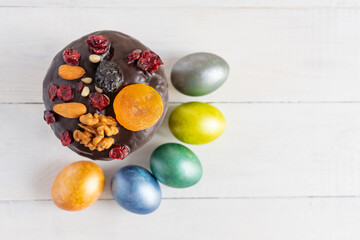 Easter cake and colored eggs on whie background. Holiday food and easter concept