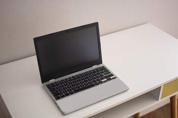 Modern workspace with laptop on desk