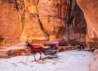 Fotobehang Petra, Jordan. Horse drawn carriage used to transport tourists to the Treasury through the Siq canyon. © SCStock