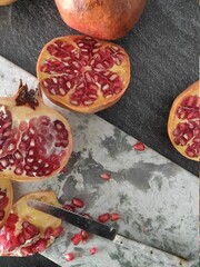 Sliced pomegranates on a marble chopping board