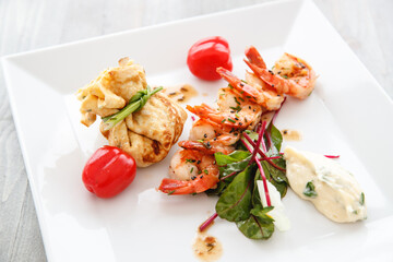 Grilled prawns and fried egg with baby spinach and tomato