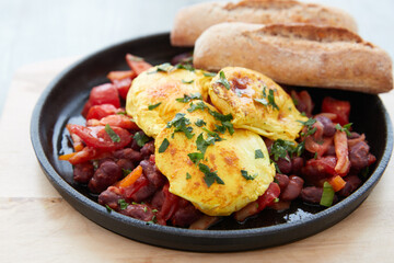 Fried egg with red beans and tomato, breads