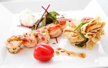 Grilled prawns and fried egg with baby spinach and tomato