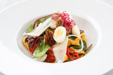 Salad with wide noodles and small egg