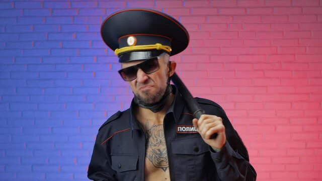 a man in a military uniform of the Russian police with a coronavirus mask yells and threatens. English translation police, Russia