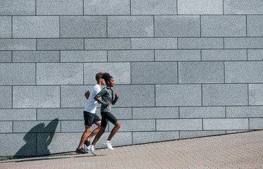 European man and african american woman in sportive clothes have workout together