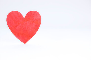 Background of one wooden heart against white background