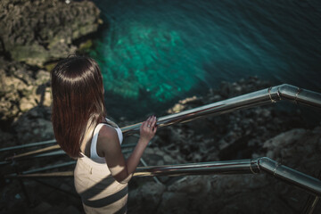 girl on a stairway over the Mediterranean sea