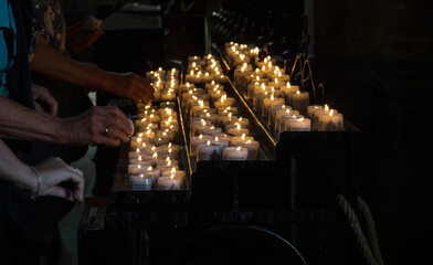 People lighting up candles in memory of deceased dead memorial remembrance in Erfurter Dom...
