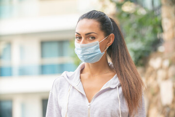 Woman wearing face mask because of Air pollution or virus epidemic in the city