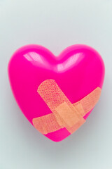 Broken heart patched with a patch. Healing love concept