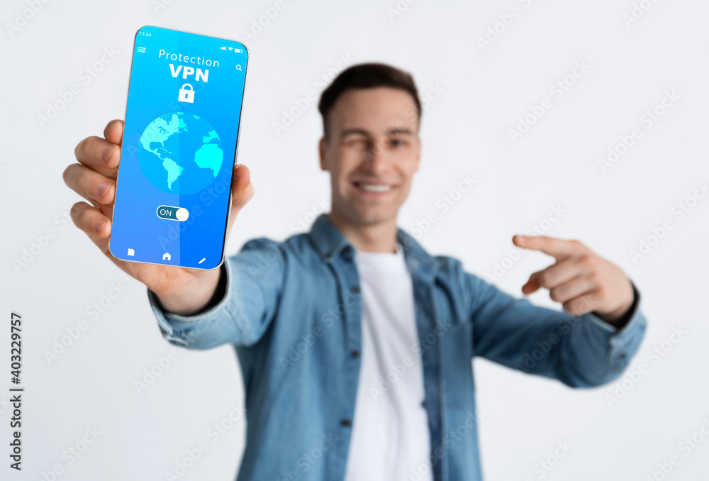 Aufkleber smiling guy holding and showing smartphone with vpn app