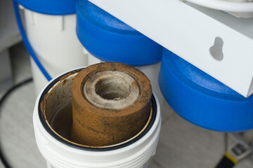 Dirty water filter cartridge used . Domestic water osmosis system at kitchen. Ecology, clean water,...