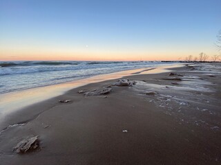 Winter sunset at Gillson Beach along Lake Michigan's Illinois shore. Waves left carvings on the beach which iced over from the frigid air.