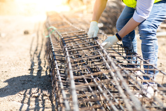 Asian Construction Worker On Building Site. Fabricating Steel Reinforcement Bar. Wearing Surgical Face Mask During Coronavirus And Flu Outbreak