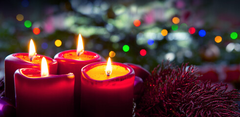 Four red candles for Advent. Christmas background.