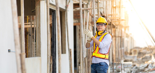 Attractive Asian engineer working on construction site. construction worker concept.