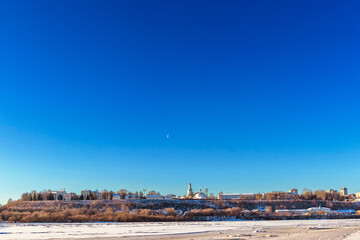 panorama of the frozen river and city on a cold winter day