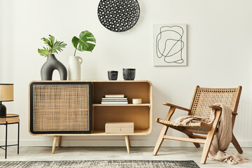 Stylish scandinavian living room interior of modern apartment with wooden commode, design armchair, carpet, leaf in vase, table lamp and personal accessories in unique home decor. Template. - obrazy, fototapety, plakaty