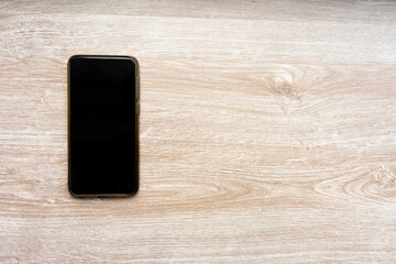 smart phone on wood background.top view, copy space for text area.