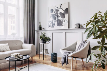 Stylish scandinavian home interior of living room with design gray sofa, armchair, marble stool, black coffee table, modern paintings, decoration, plant and elegant personal accessories in home decor.