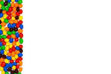 Postcard made of colored chocolate round candies. Space for text. Top view, flat lay.