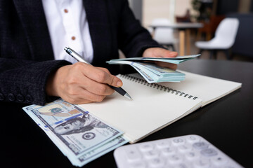 businesswoman counting money, finance, saving, banking, and people concept - close up of woman hands counting us dollar money