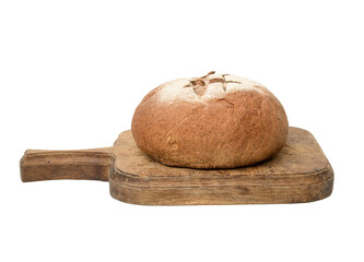 baked round rye flour bread on brown wooden board, loaf of bread isolated